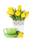 Yellow tulips and tea cup