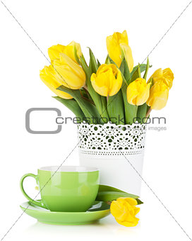 Yellow tulips and tea cup