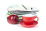 Red coffee cup, ripe apple and office supplies