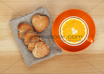 Cup with orange and cookies