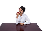 Businesswoman eating an apple