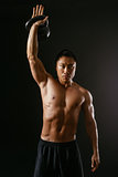 Asian man working out with kettle bell