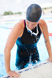 Female swimmer exiting pool