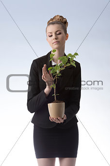happy businesswoman with money plant 