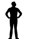 one business man standing hands on hips silhouette