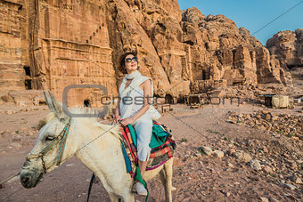 tourist riding donkey  in nabatean city of  petra jordan