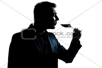 silhouette man portrait smelling red wine glass