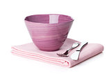 Salad bowl and silverware over kitchen towel