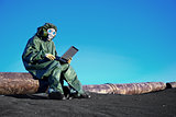 Scientist with a laptop on chemically contaminated area
