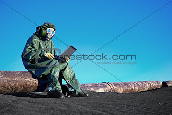 Scientist with a laptop on chemically contaminated area