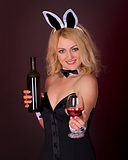 Beautiful young girl dressed as a rabbit with wine