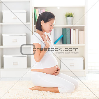 Pregnant Asian woman with nausea
