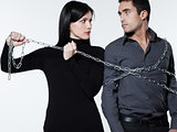 woman restraining a man chained