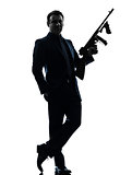 gangster man holding thompson machine gun silhouette
