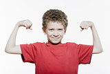 Little boy portrait strong flexing muscle biceps