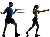 woman exercising fitness resistance  rubber band with man coach