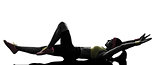 woman exercising fitness stretching lying on back   silhouette