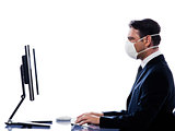 Caucasian Man portrait with computer wearing protection mask