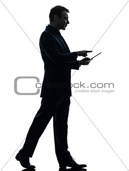 business man walking touchscreen digital tablet  silhouette