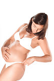 Pregnant woman examining her hips