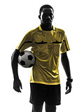 one african man referee standing holding football silhouette