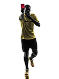one african man referee standing showing red card  silhouette