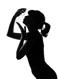 silhouette woman kissing her perfume