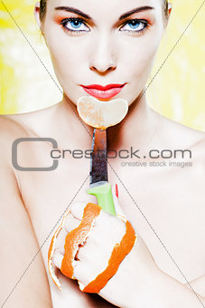 Woman Portrait holding a orange tangerine fruit slice