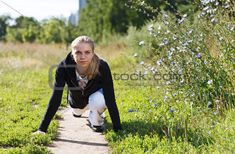 Young woman doing push ups in the park