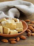 almond paste - marzipan in a bowl with whole nuts