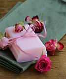 homemade soap with roses on a wooden table