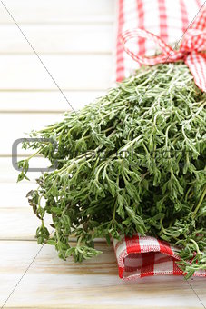 bunch of fresh fragrant  thyme on a wooden background
