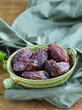 sweet dates in bowl on a wooden table