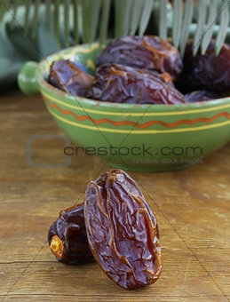 sweet dates in bowl on a wooden table
