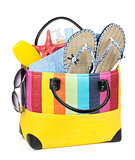 Bag with towels, sunglasses, flip-flops and beach items