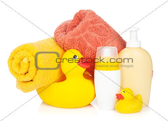 Rubber duck with bath towel and bottles
