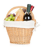 Picnic basket with bread, cheese, grape and wine bottles