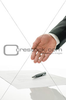Businessman gesturing to sign a paper
