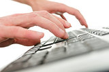Closeup of  young man hands typing on computer keyboard