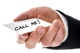 Closeup of a business man handing card with Call me message
