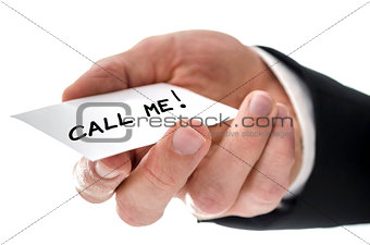 Closeup of a business man handing card with Call me message