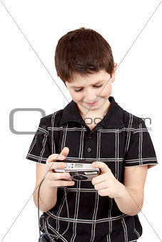 small boy checking analog camera settings