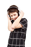 Portrait of a happy smiling young boy listening to music on head