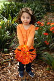 Beautiful little girll with a bunch of clivia from the garden