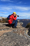 Photographer taking photos of mountain landscape