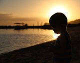 Little boy silhouette at the beach