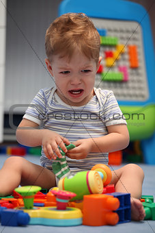 A baby boy crying in children's room