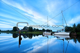 yachts on river during calm morning