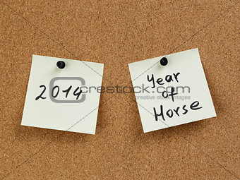 horse year reminder note on cork board