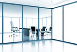 Empty meeting room behind a glass partition in modern cubicle